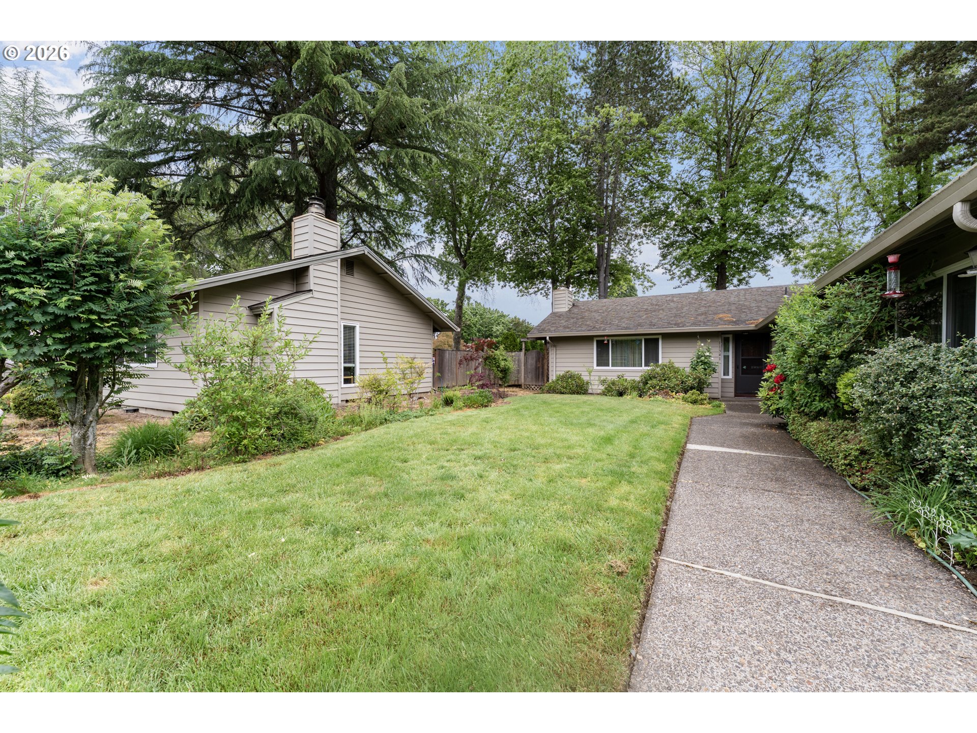 11341 Southwest Springwood Drive Portland, OR 97223 - Photo 2 of 26 a front view of a house with a yard