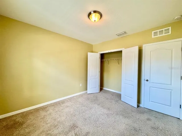 a view of a big room with wooden floor and cabinet