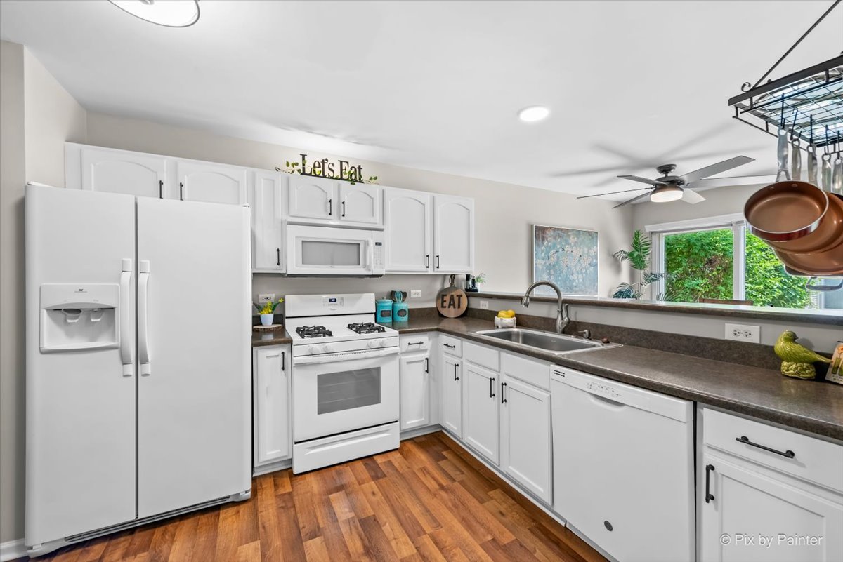 10884 Cape Cod Lane Huntley, IL 60142 - Photo 12 of 22 a kitchen with a sink cabinets stainless steel appliances and a window