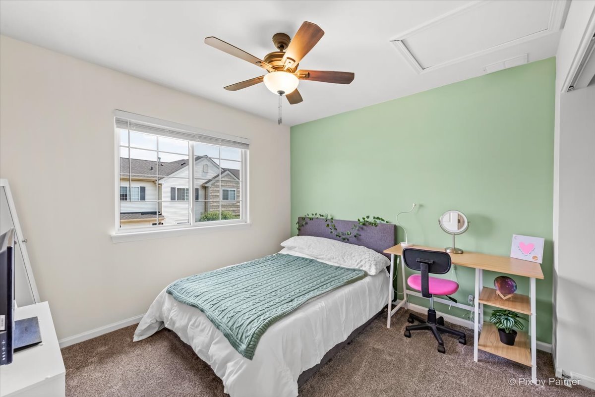 10884 Cape Cod Lane Huntley, IL 60142 - Photo 15 of 22 a bedroom with a bed and a chandelier