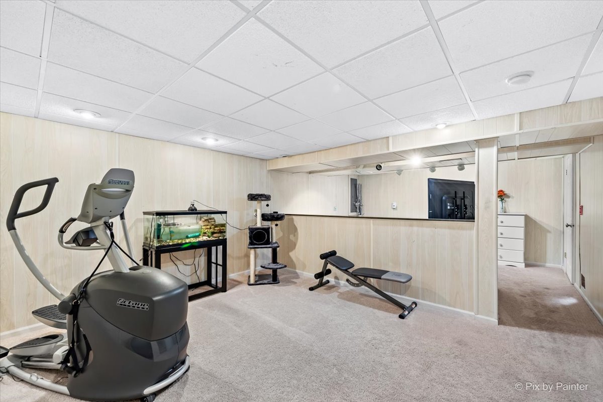 10884 Cape Cod Lane Huntley, IL 60142 - Photo 18 of 22 a room with gym equipment and a flat screen tv
