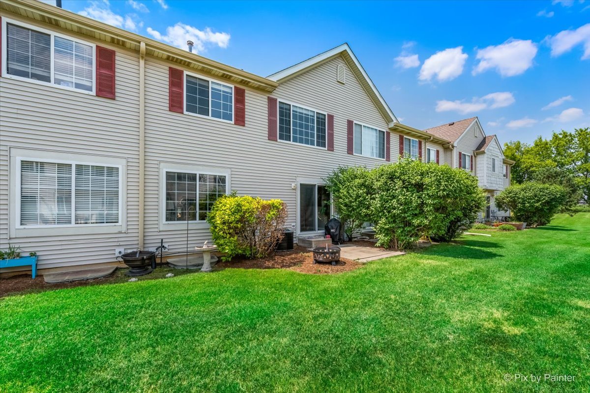 10884 Cape Cod Lane Huntley, IL 60142 - Photo 21 of 22 a front view of a house with garden and yard