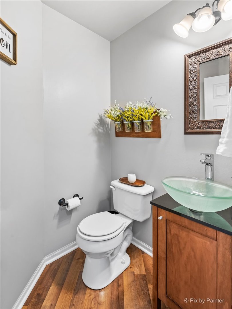 10884 Cape Cod Lane Huntley, IL 60142 - Photo 4 of 22 a bathroom with a toilet sink and mirror