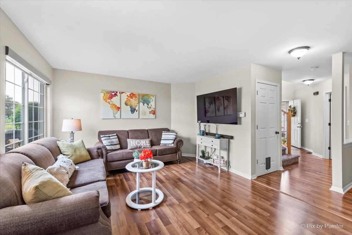 10884 Cape Cod Lane Huntley, IL 60142 - Photo 5 of 22 a living room with furniture and a flat screen tv