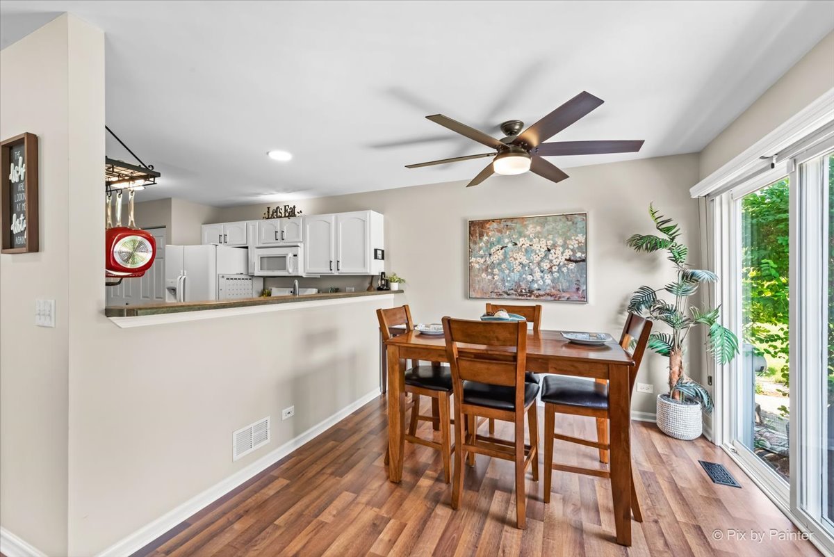 10884 Cape Cod Lane Huntley, IL 60142 - Photo 9 of 22 a view of a dining room with furniture window and wooden floor