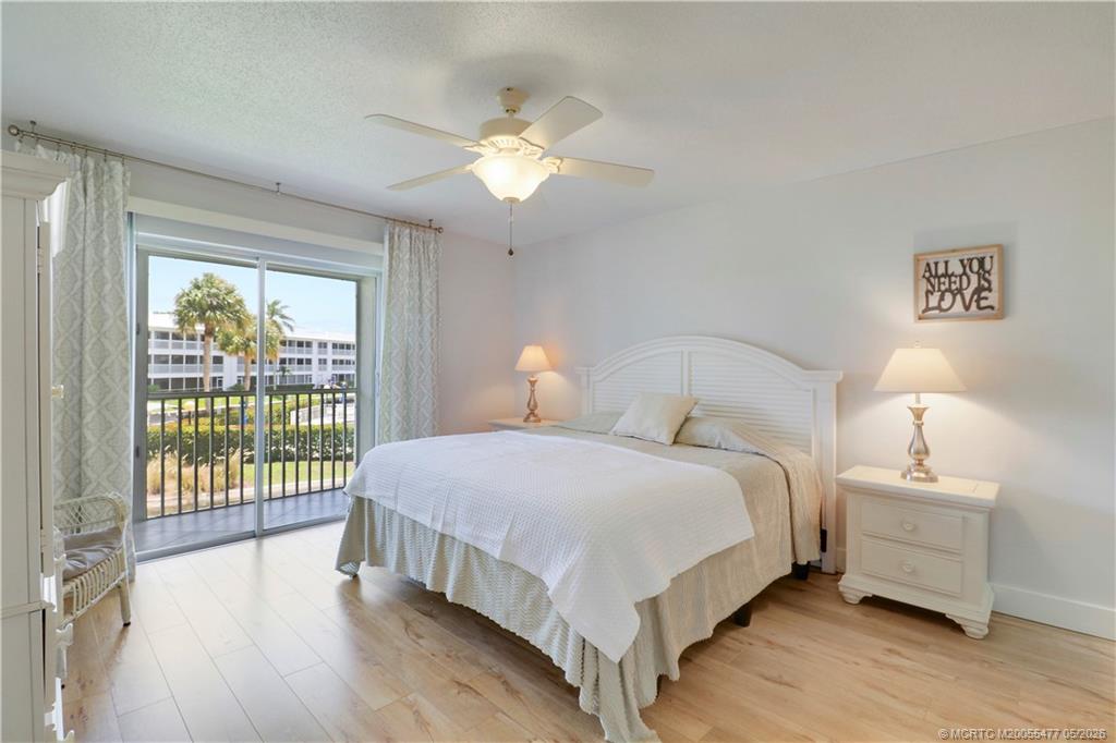 1852 Southwest Palm City Road, Unit 201 Stuart, FL 34994 - Photo 18 of 34 a bedroom with a bed and a night stand