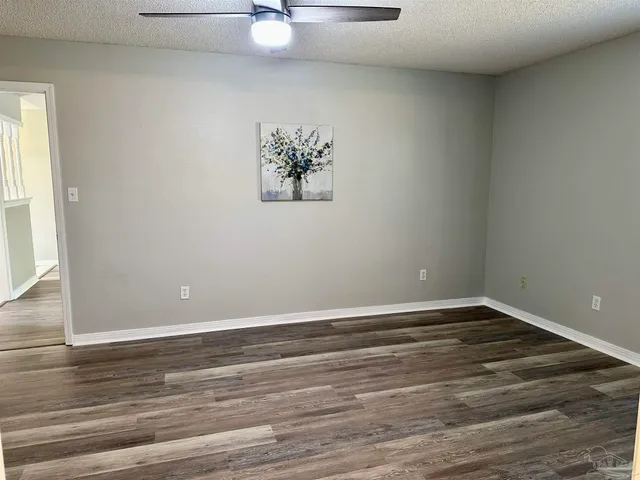 a view of a room with wooden floor