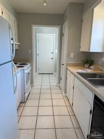 a kitchen with a sink a stove and refrigerator
