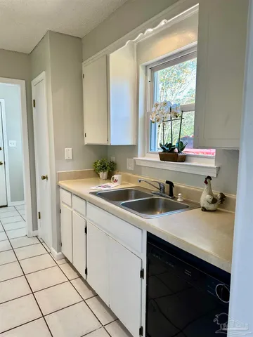 a kitchen with a sink cabinets and window