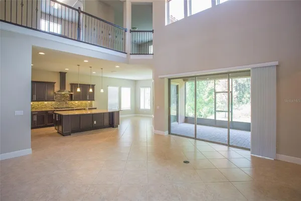 a view of a kitchen with a sink and a refrigerator