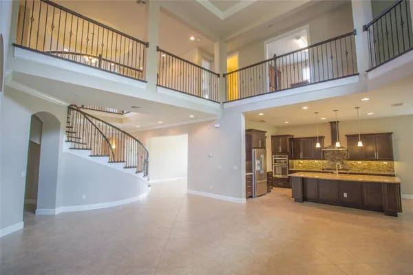 a large kitchen with stainless steel appliances granite countertop a large counter top and a stove