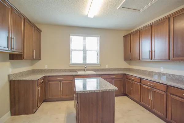 an aerial view of a house with a garden and lake view