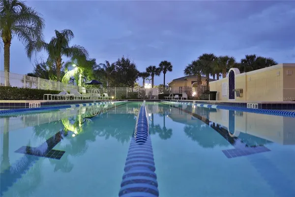 an aerial view of a house with swimming pool and lake view