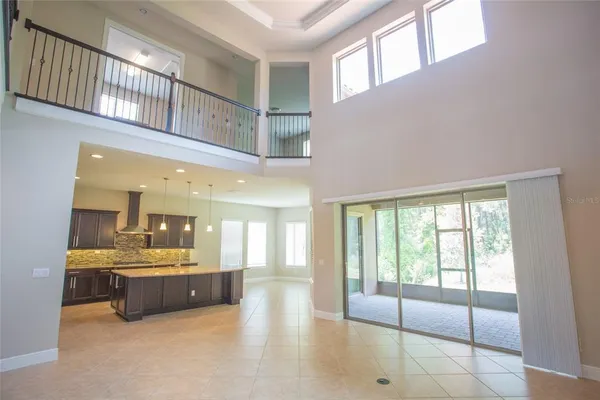 a large white kitchen with a large window