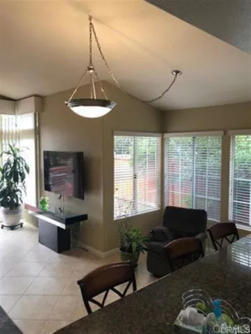 a living room with furniture a chandelier and a window