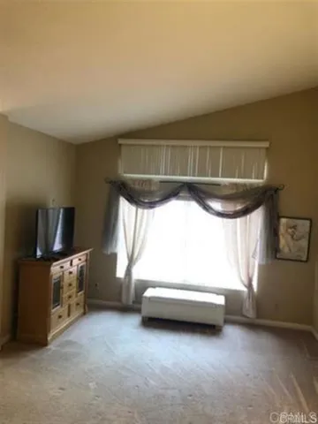 a view of room with window and furniture