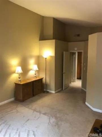 a view of a room with a table and chairs