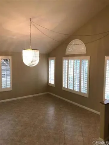 an empty room with a empty space and windows