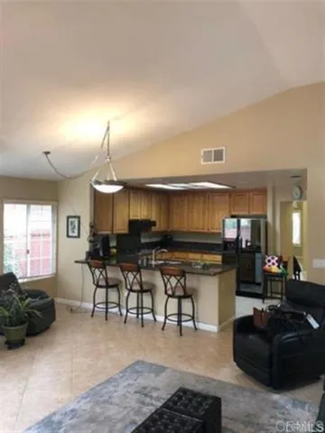 a living room with furniture a large window and a potted plant