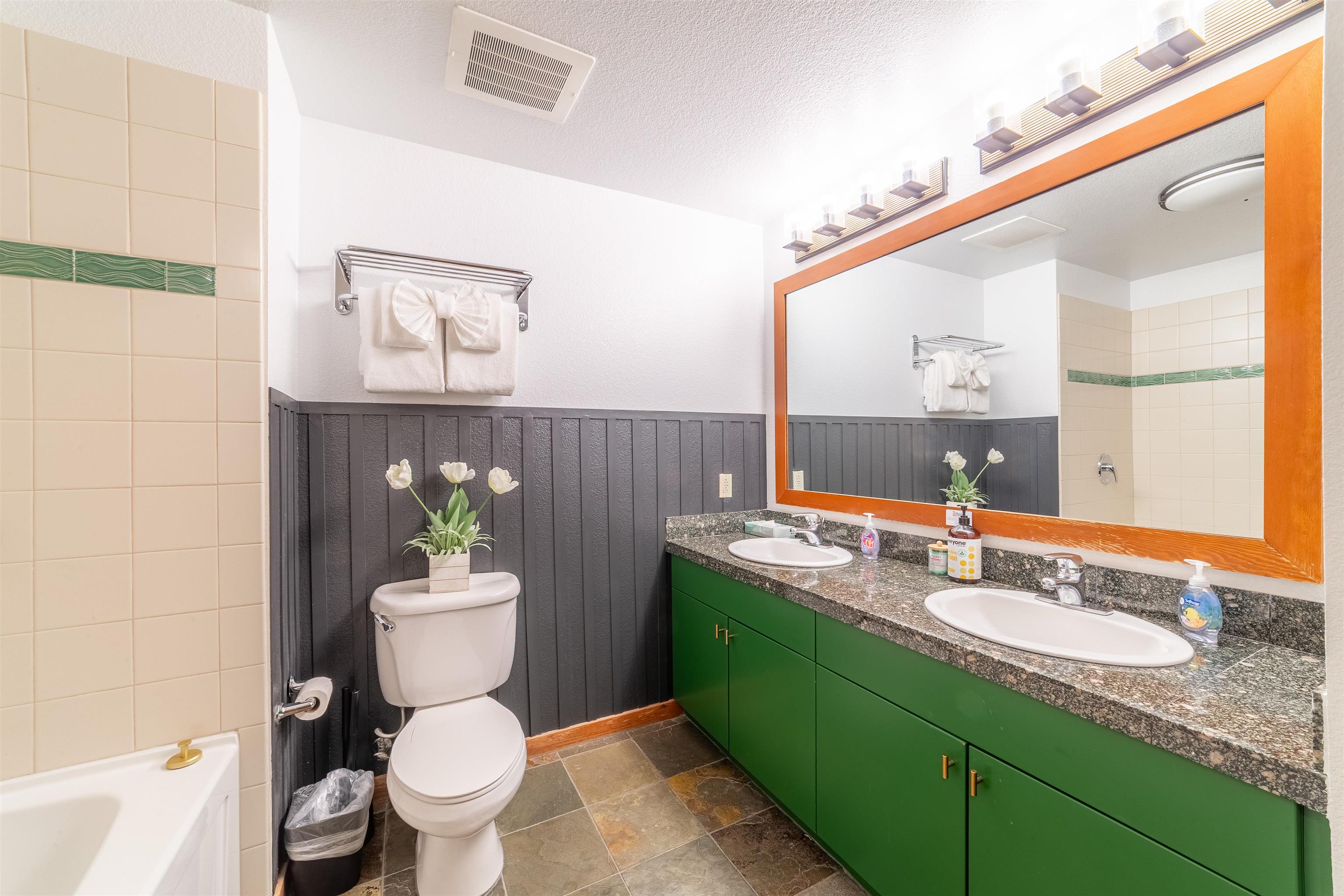 6201 Minaret Road, Unit 2221 Mammoth Lakes, CA 93546 - Photo 36 of 44 Bathroom featuring a dual vanity with green cabinetry and a speckled countertop