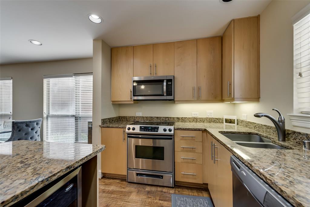 4973 Thunder Road, Unit B Dallas, TX 75244 - Photo 13 of 22 a kitchen with a stove and a sink