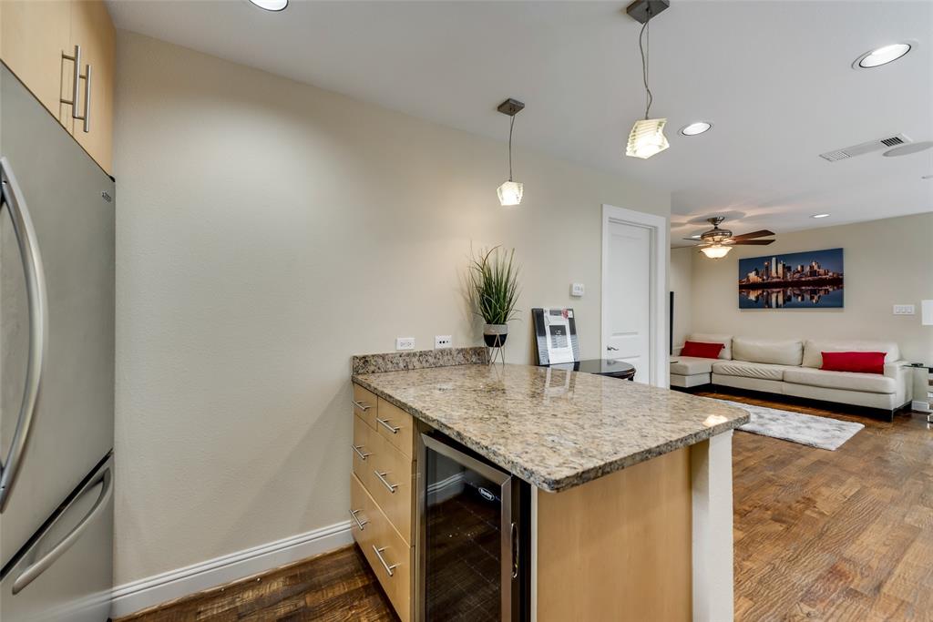 4973 Thunder Road, Unit B Dallas, TX 75244 - Photo 14 of 22 a view of a kitchen center island and stainless steel appliances