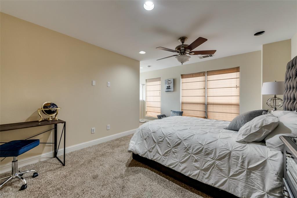 4973 Thunder Road, Unit B Dallas, TX 75244 - Photo 17 of 22 a bedroom with a bed and a ceiling fan