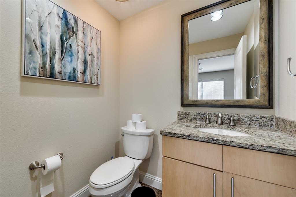 4973 Thunder Road, Unit B Dallas, TX 75244 - Photo 10 of 22 a bathroom with a granite countertop toilet a sink and mirror