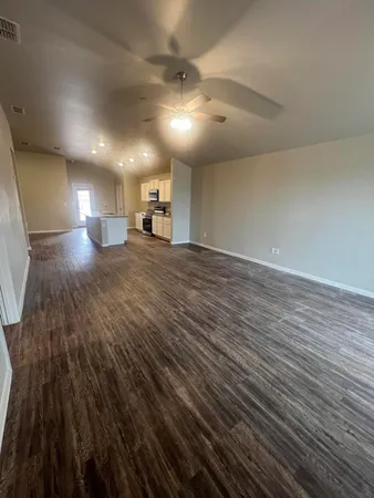 a view of a room with wooden floor
