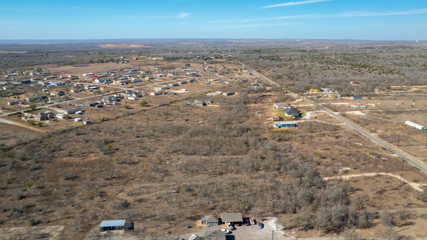 3991 Barth Road Lockhart, TX 78644 - Photo 27 of 27 Aerial view of property and surrounding area featuring a desert landscape and rural landscape