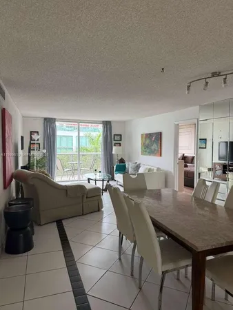 a kitchen with stainless steel appliances white cabinets and a refrigerator