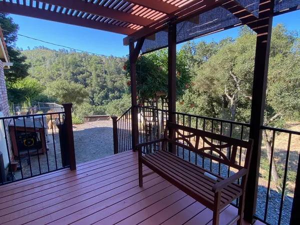a view of a balcony with furniture and wooden floor