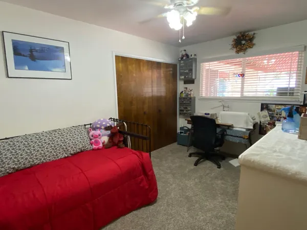 a bedroom with a bed and window