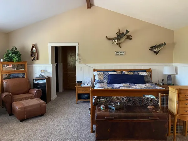 a bedroom with furniture and a lamp