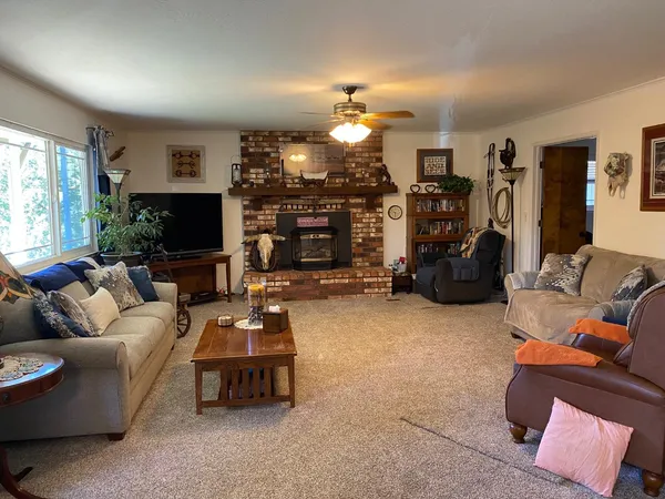 a living room with furniture a flat screen tv and a fireplace