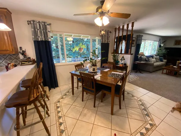 a view of a dining room with furniture window and outside view