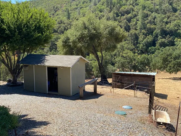 a view of backyard with a table and chairs and a barbeque