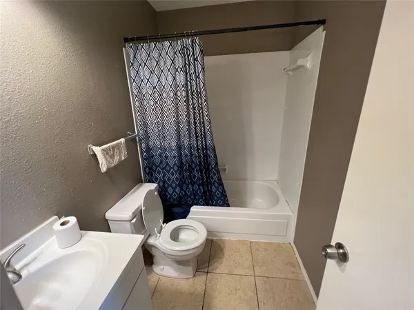 a bathroom with a toilet and shower