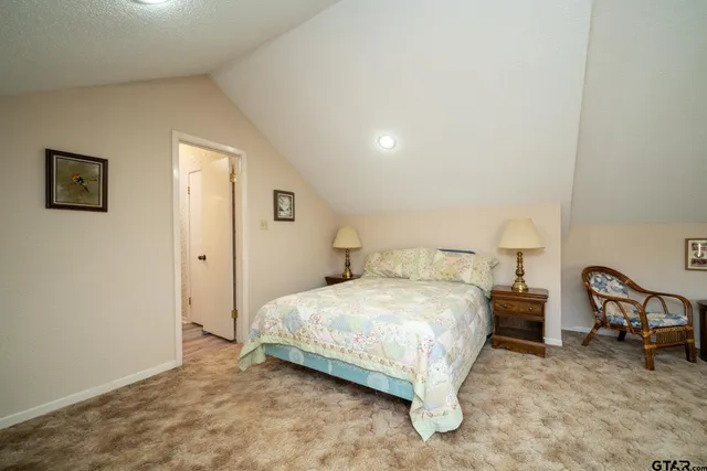 a bedroom with a bed a table and chair