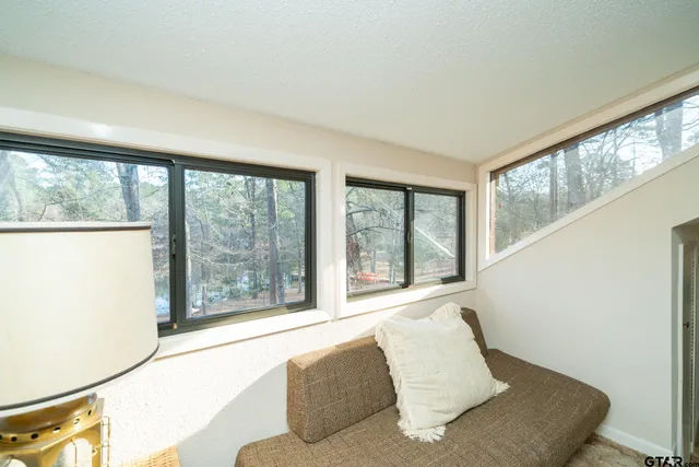 a living room with a large window and a couch