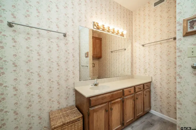 a bathroom with a sink a mirror and a shower