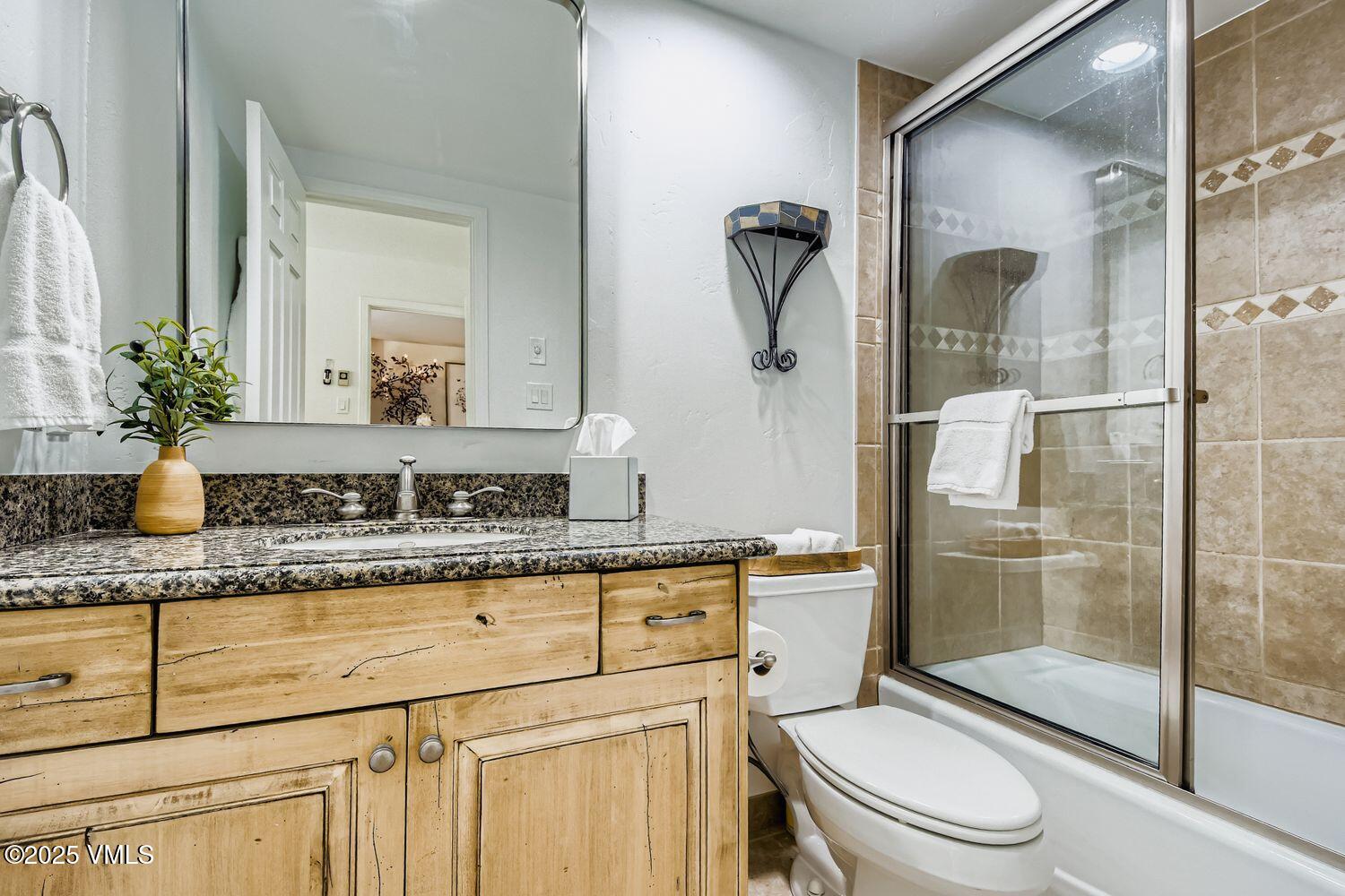 1120 Village Road, Unit 204 Beaver Creek, CO 81620 - Photo 14 of 29 a bathroom with a granite countertop sink a toilet and shower