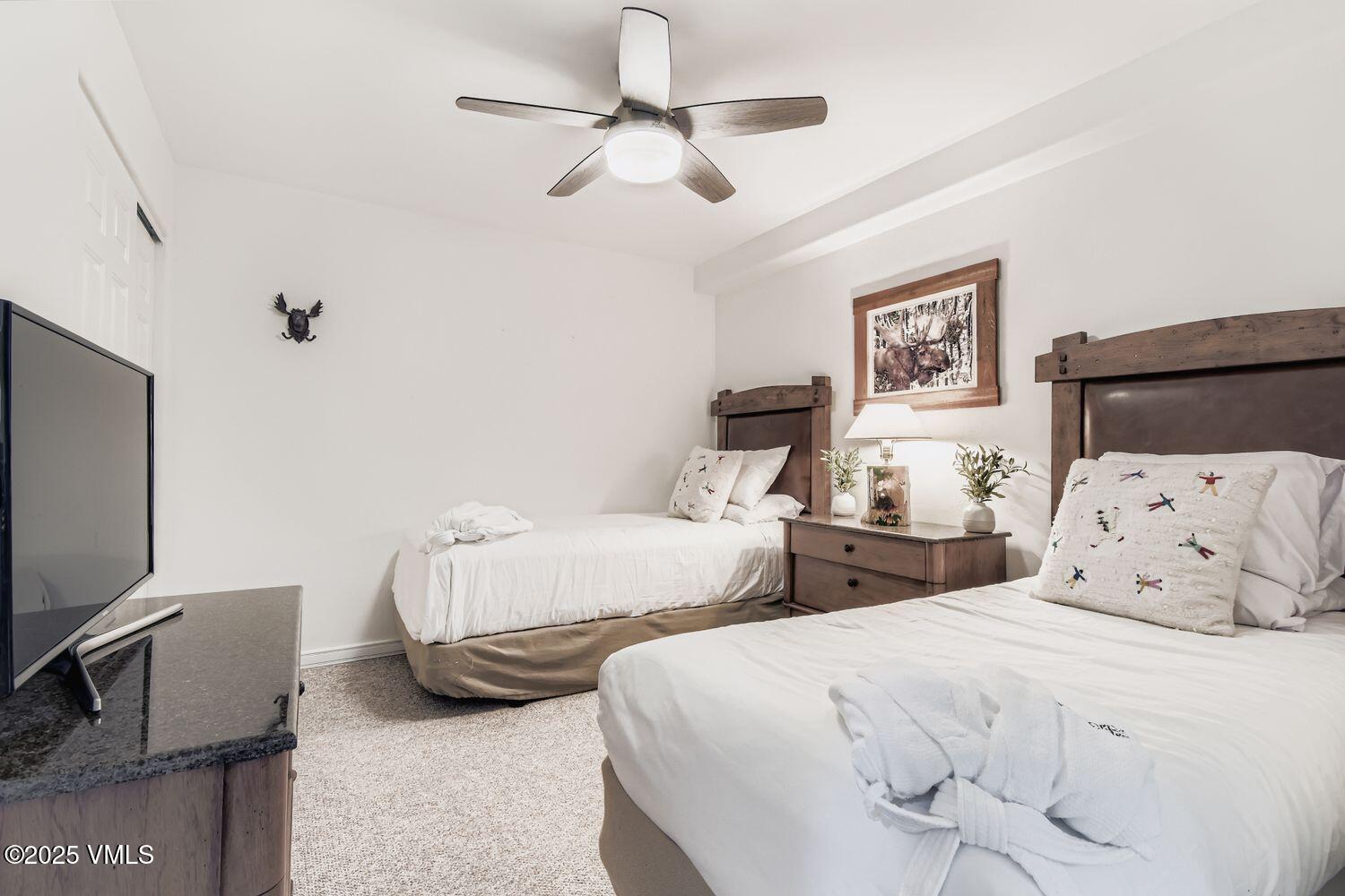 1120 Village Road, Unit 204 Beaver Creek, CO 81620 - Photo 15 of 29 a bedroom with two beds and a flat screen tv