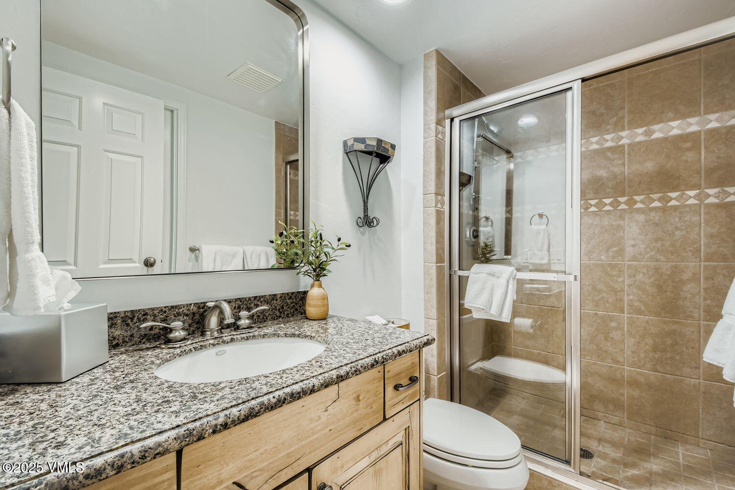 1120 Village Road, Unit 204 Beaver Creek, CO 81620 - Photo 16 of 29 a bathroom with a granite countertop sink toilet and shower