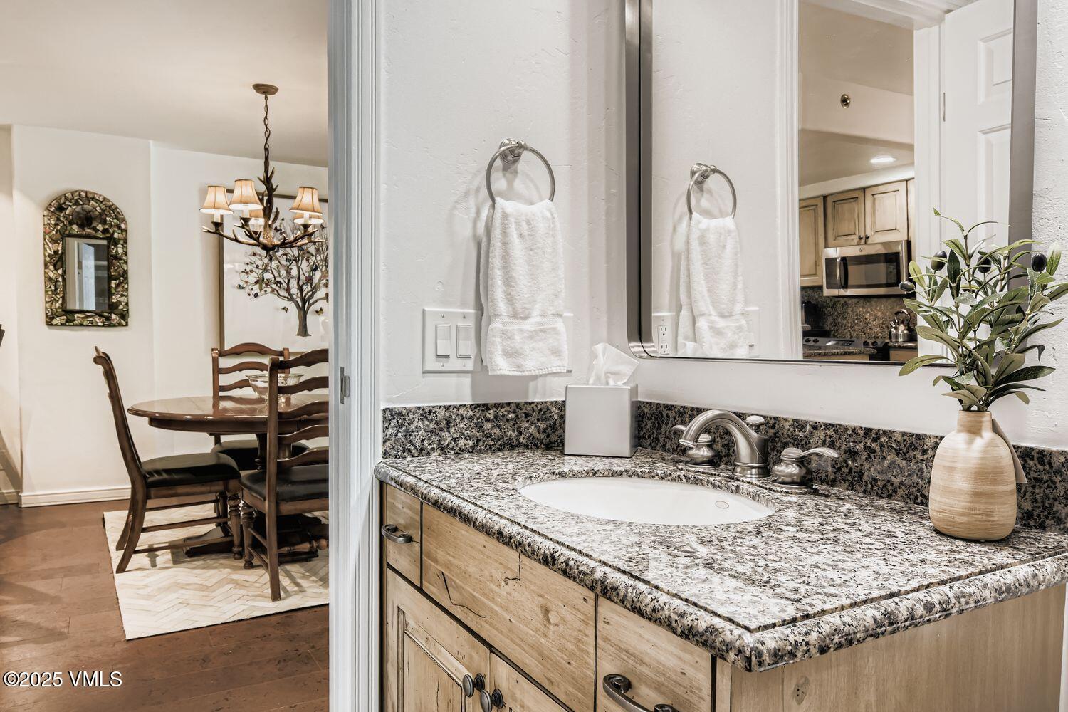 1120 Village Road, Unit 204 Beaver Creek, CO 81620 - Photo 17 of 29 a bathroom with a granite countertop sink and a mirror