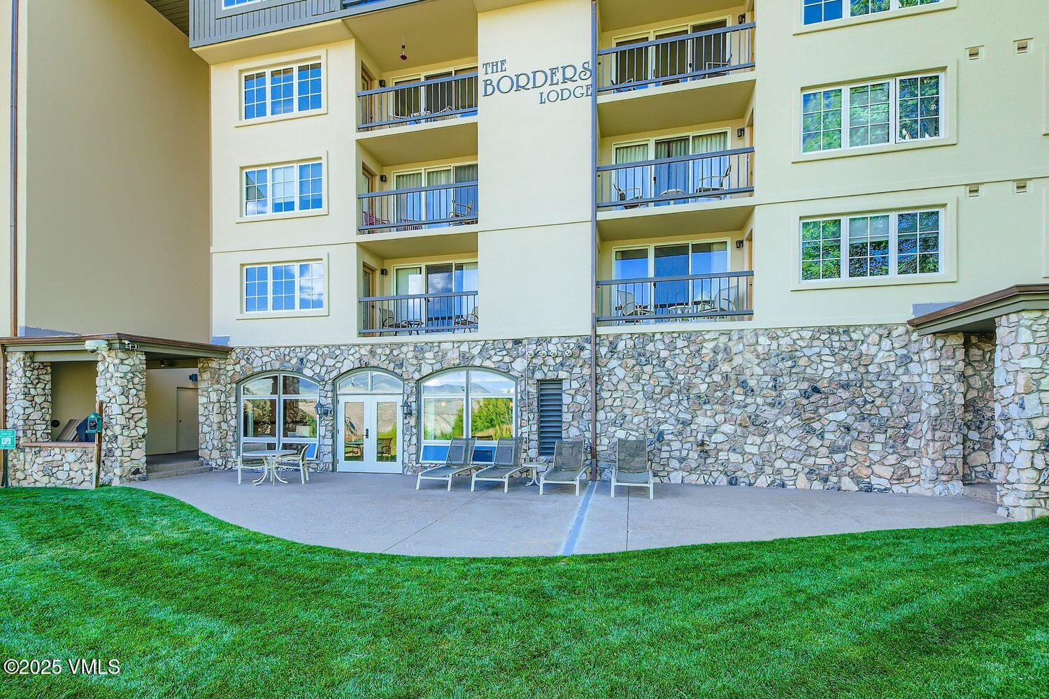 1120 Village Road, Unit 204 Beaver Creek, CO 81620 - Photo 19 of 29 a view of a brick building next to a yard