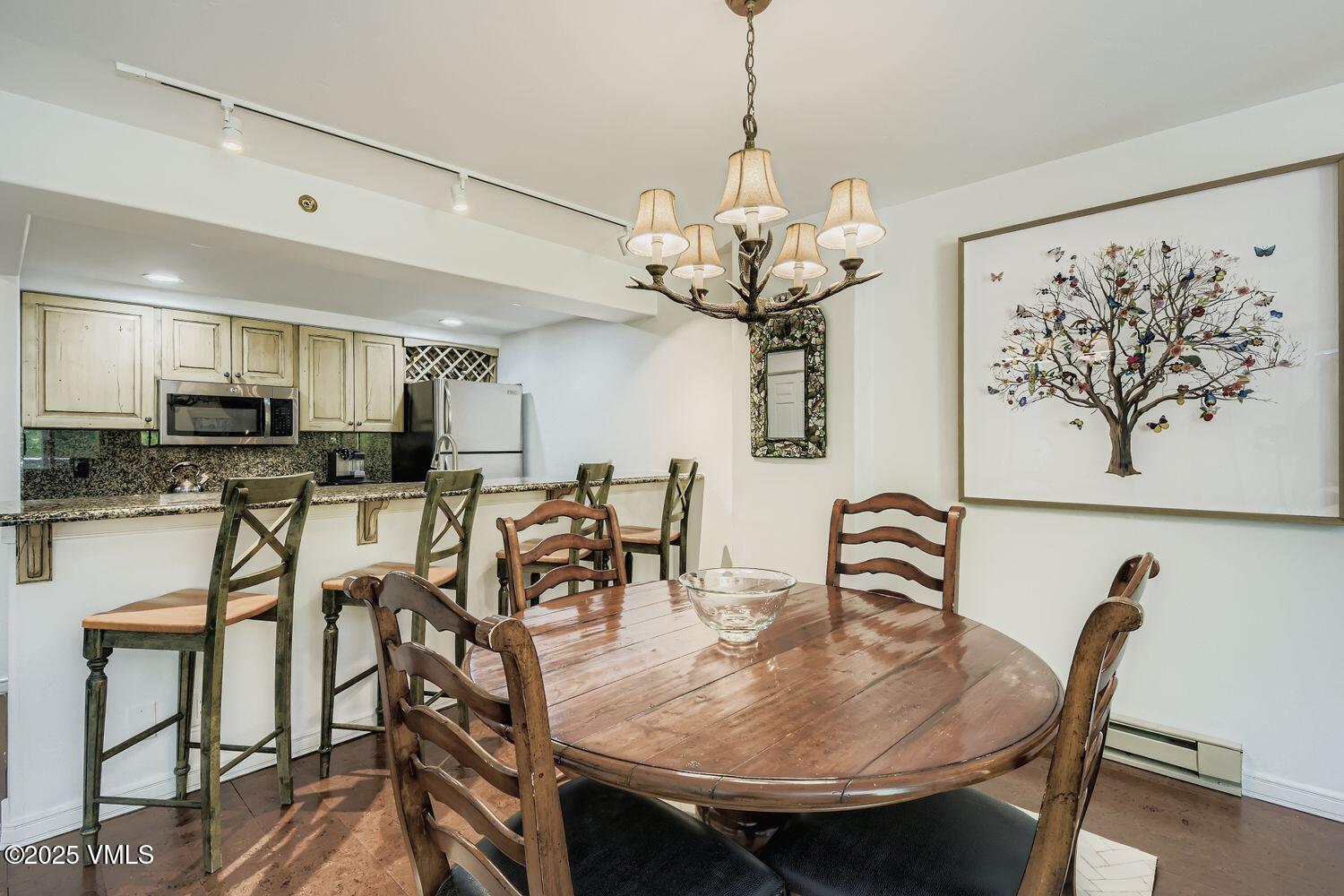 1120 Village Road, Unit 204 Beaver Creek, CO 81620 - Photo 7 of 29 a view of a dining room with furniture wooden floor and chandelier