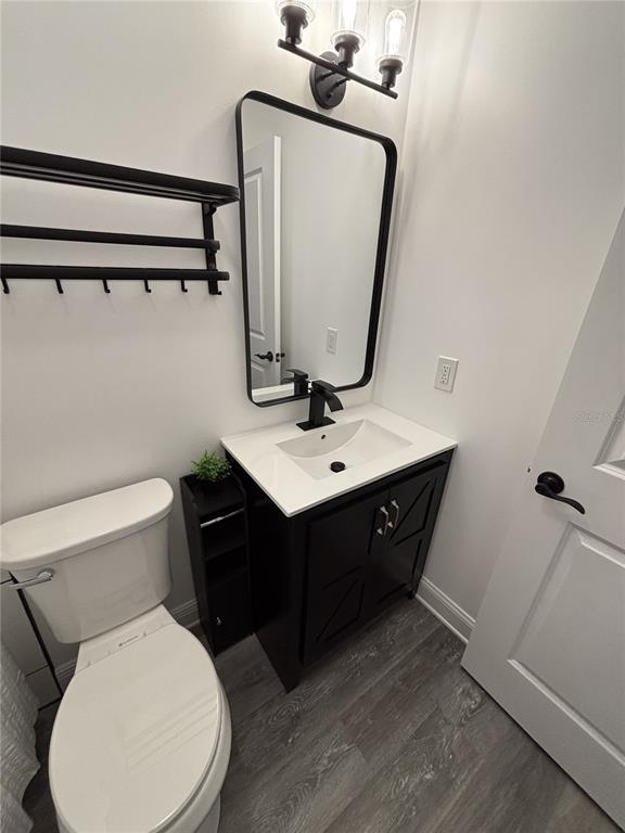 2911 Williams Road Plant City, FL 33565 - Photo 39 of 51 a bathroom with a toilet sink and mirror