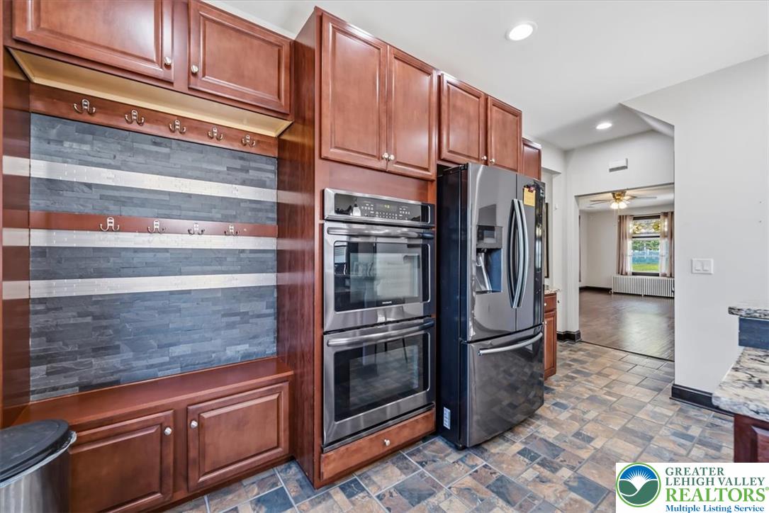3453 Main Street Slatington, PA 18080 - Photo 7 of 30 A well-appointed kitchen showcasing modern appliances and rich wood cabinetry with integrated storage.