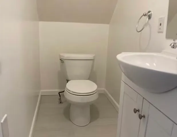 a white toilet sitting next to a white sink